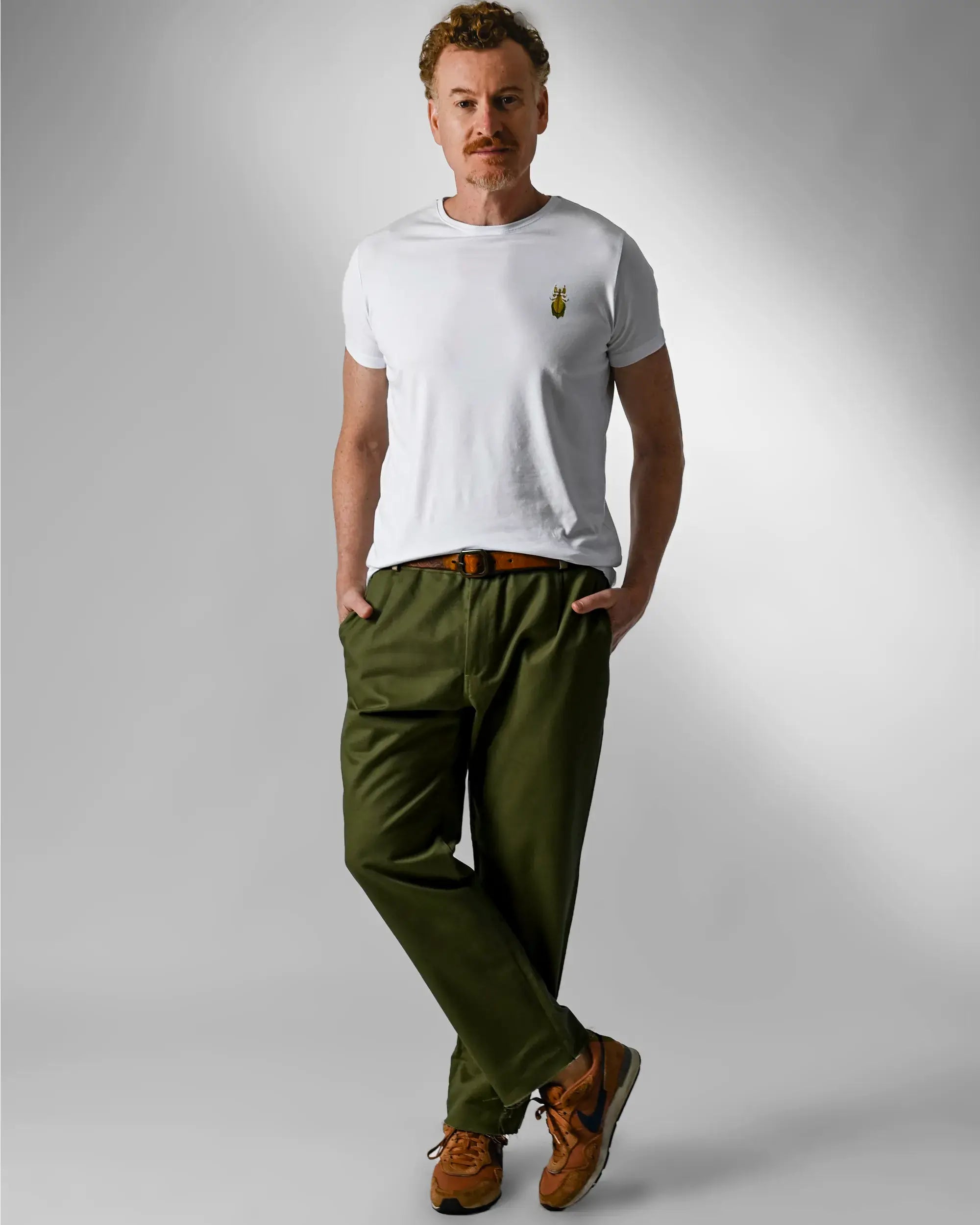 modelo usando camiseta branca e calça sarja verde oliva
